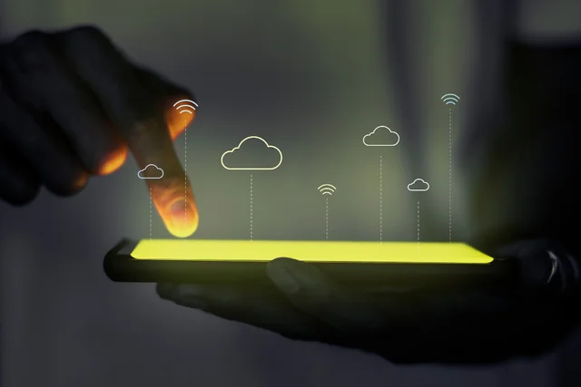 Hand using a tablet with cloud infrastructure symbols
